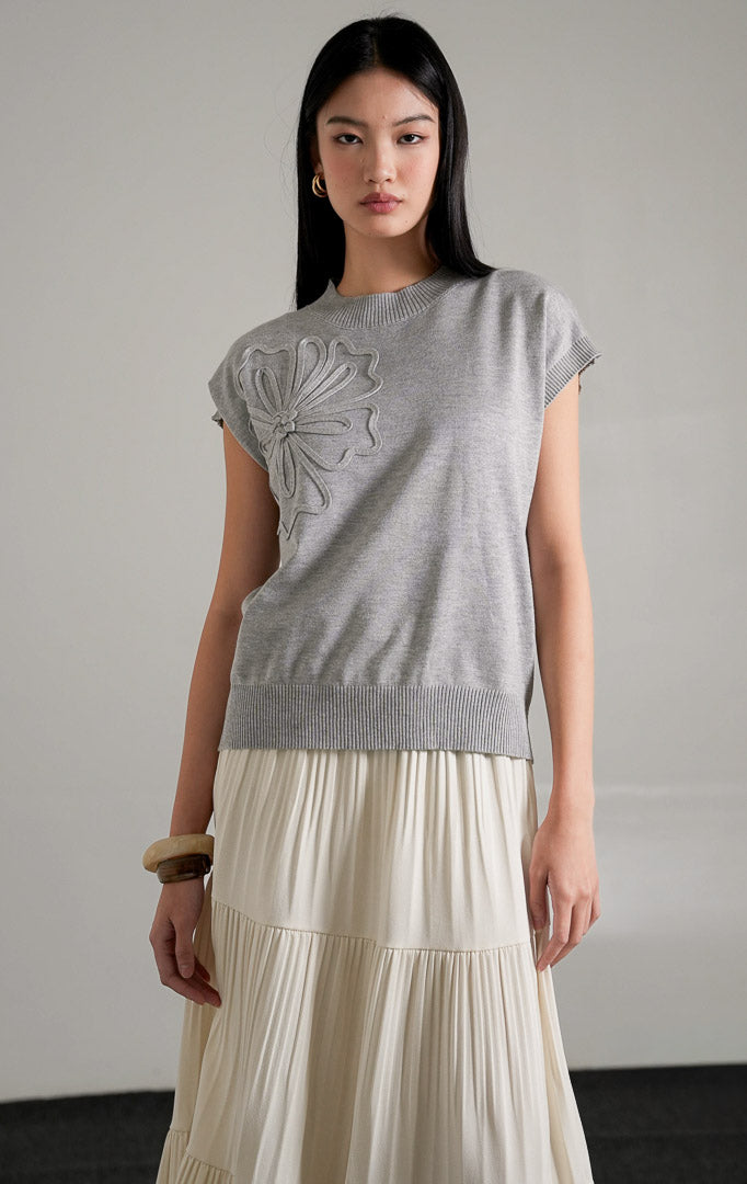 Close-up of delicate flower details and comfortable knit fabric on the Ailynn sleeveless top.