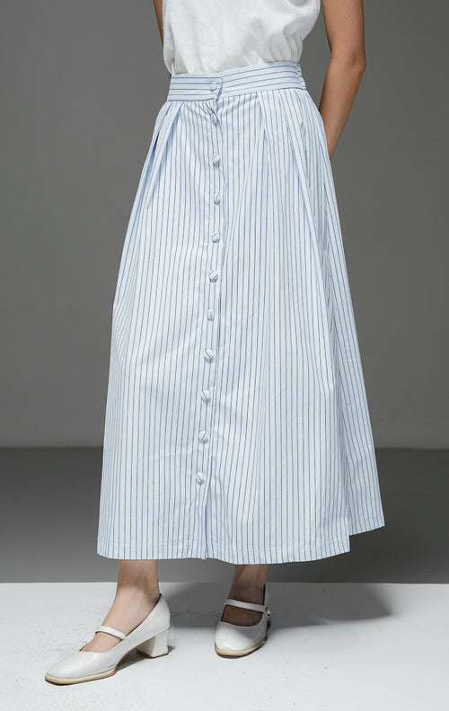 Rok midi wanita Artemis Skirt warna light blue biru muda motif salur garis vertikal dengan kancing depan berlaput kain, detail pleat, dan pinggang karet.