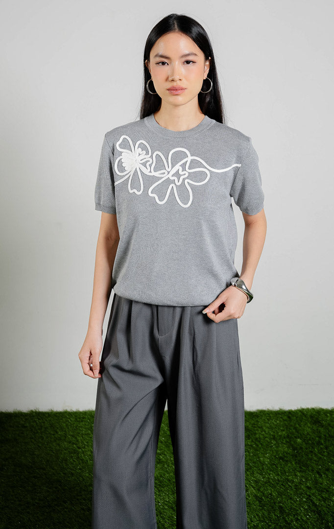 Nadeleine Floral Cord Knit Top warna grey, baju atasan rajut lengan pendek wanita warna abu-abu dengan detail rajutan tali bentuk bunga warna putih dari This Is April.