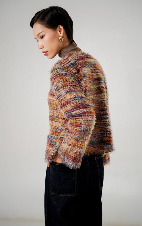 Cardigan rajut wanita Sophia Top Brown dengan tekstur eyelash (bulu halus), motif garis warna warni (earthy tones), dan detail kancing logam emas bulat. Baju Knitwear Kekinian