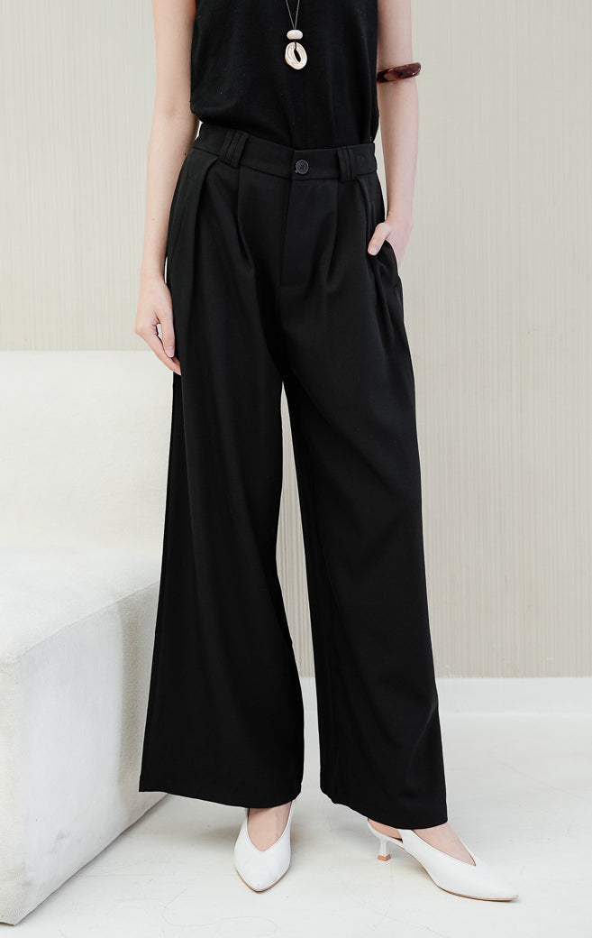 Celana panjang kulot wanita Kalia Pleats Wide Leg Pants warna black (hitam) berpotongan wide-leg dengan aksen lipit depan (pleats) dan saku samping untuk formal & casual look.