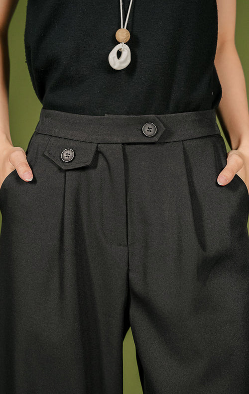Celana panjang wanita Margo Pants berpotongan lurus (straight cut) warna hitam, dilengkapi detail dua kancing pada ban pinggang depan serta karet elastis di pinggang bagian belakang.