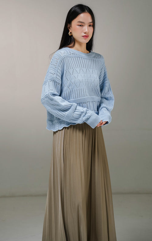 Atasan sweater rajut lengan panjang wanita This Is April Clarissa Sweater warna biru muda, model jaring mesh knit transparan dengan variasi pola rajutan belah ketupat dan garis vertikal.