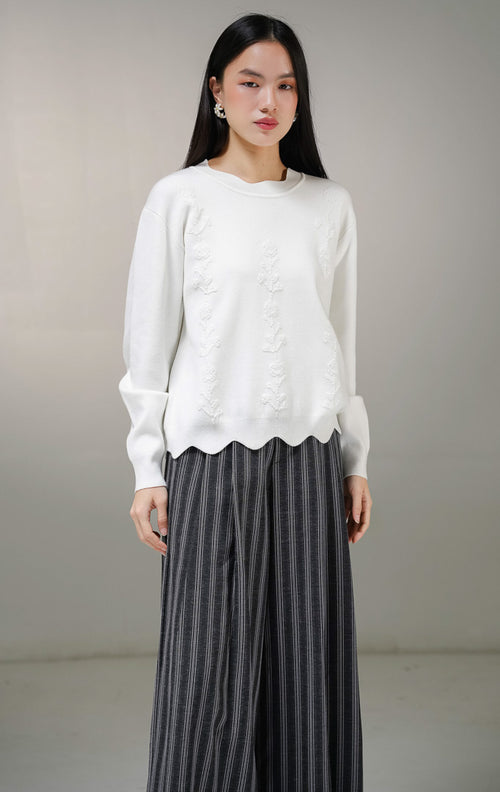 Atasan sweater rajut lengan panjang wanita This Is April Galina Sweater warna putih dengan detail tiga lajur motif bunga timbul (bertekstur) di bagian depan.