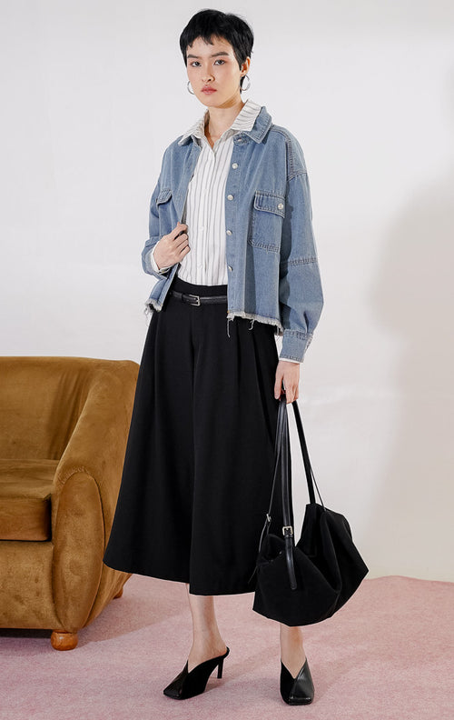 Atasan kemeja denim wanita This Is April Katanna Top warna biru dengan kerah klasik, full kancing depan, dua saku dada, dan detail pinggiran bawah raw hem