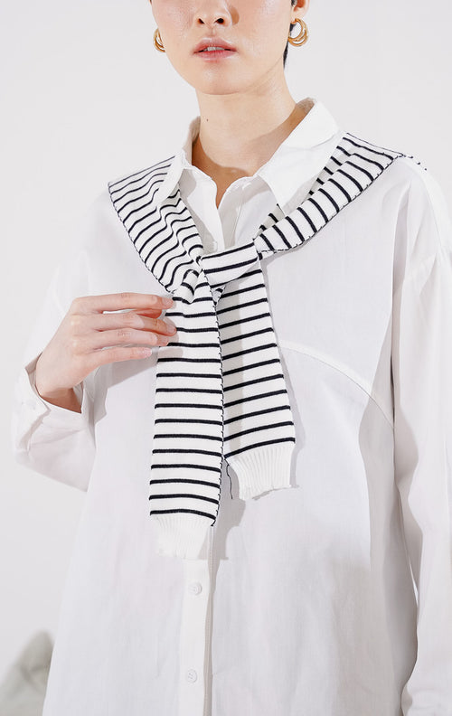 Kemeja wanita lengan panjang Krystal Top dari This Is April berwarna putih bersih berkerah klasik, dilengkapi dengan kancing depan dan aksen syal rajut motif garis hitam putih yang diikatkan di kerah