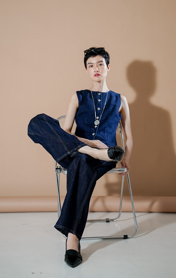 Lilou Vest Dark Denim dari This Is April, rompi waistcoat denim wanita warna biru gelap dengan deretan kancing perak di bagian depan dan siluet ramping terstruktur.