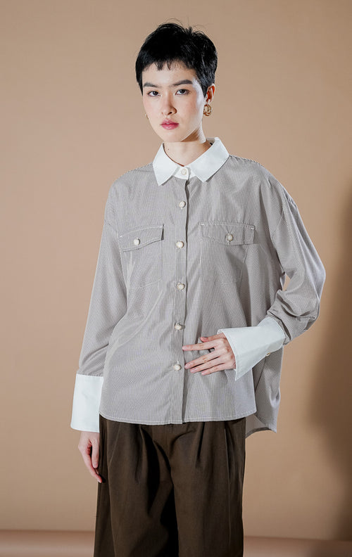 Merveille Top Brown Stripe dari This Is April, kemeja lengan panjang wanita motif garis cokelat putih dengan kerah dan ujung lengan warna putih kontras serta dua saku depan.
