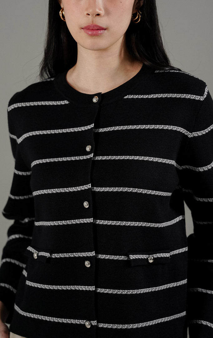 Gabrielle Cardigan Black dari This Is April, cardigan rajut hitam motif garis putih (stripe) dengan kancing metalik dan detail faux pocket.