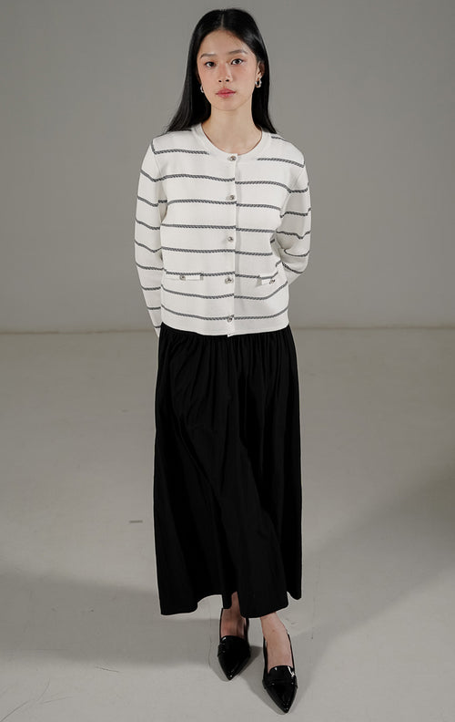 Gabrielle Cardigan White dari This Is April, cardigan rajut putih motif garis hitam dengan kancing perak dan detail saku dekoratif.