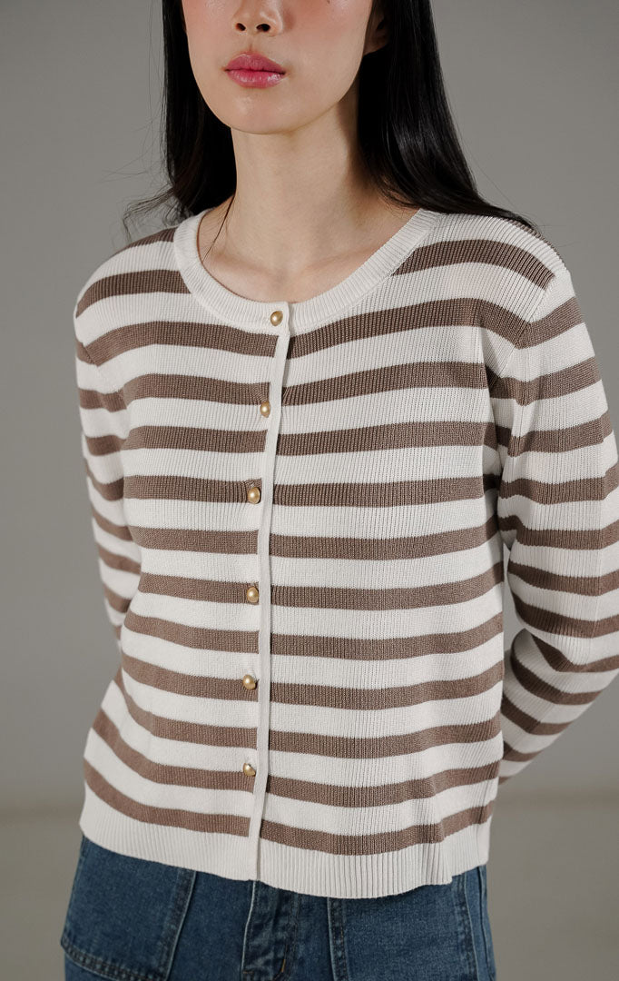 Lyra Cardigan Taupe dari This Is April, cardigan rajut lengan panjang motif garis warna putih dan taupe dengan detail kancing emas.