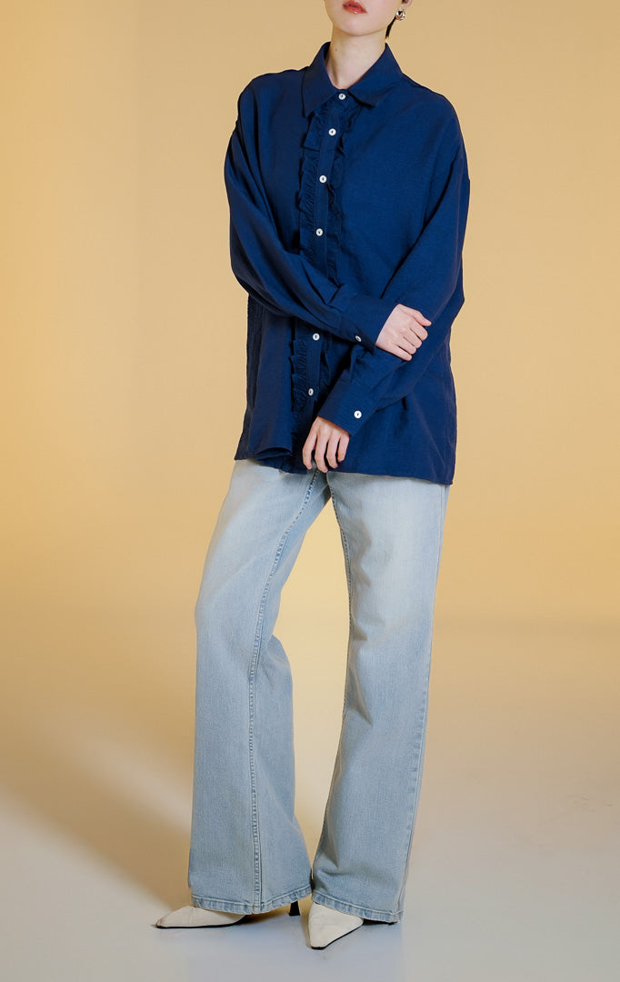 Pakaian wanita model kemeja lengan panjang berkerah dengan detail kerutan rempel di sepanjang kancing depan (dual-sided ruffled placket shirt) warna navy Mirena Top untuk gaya kantor dan kasual anggun.