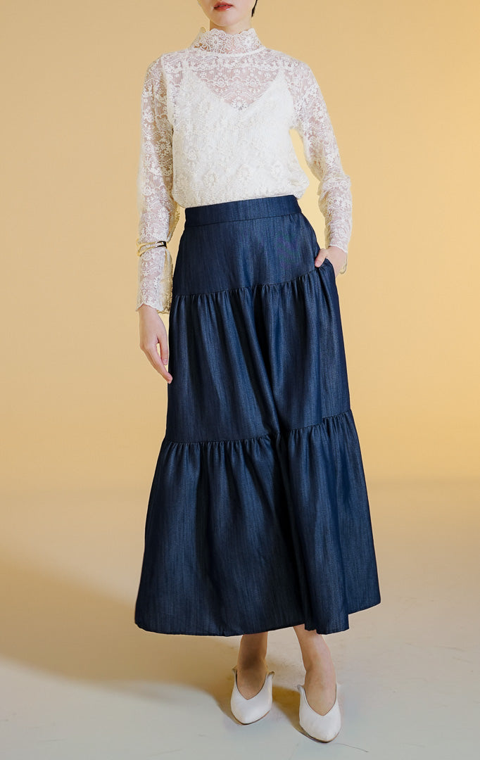 Pakaian wanita model rok panjang maxi bertingkat bahan jeans (tiered denim maxi skirt) warna dark denim Morita Skirt untuk gaya kantor dan kasual anggun.