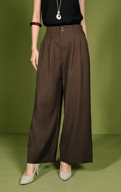 Celana panjang wanita Vincent Pants berpotongan lurus (straight cut) warna cokelat, dilengkapi detail dua kancing bersusun (double button) di ban pinggang depan, aksen lipatan (pleats), saku samping, dan karet elastis di pinggang bagian belakang.