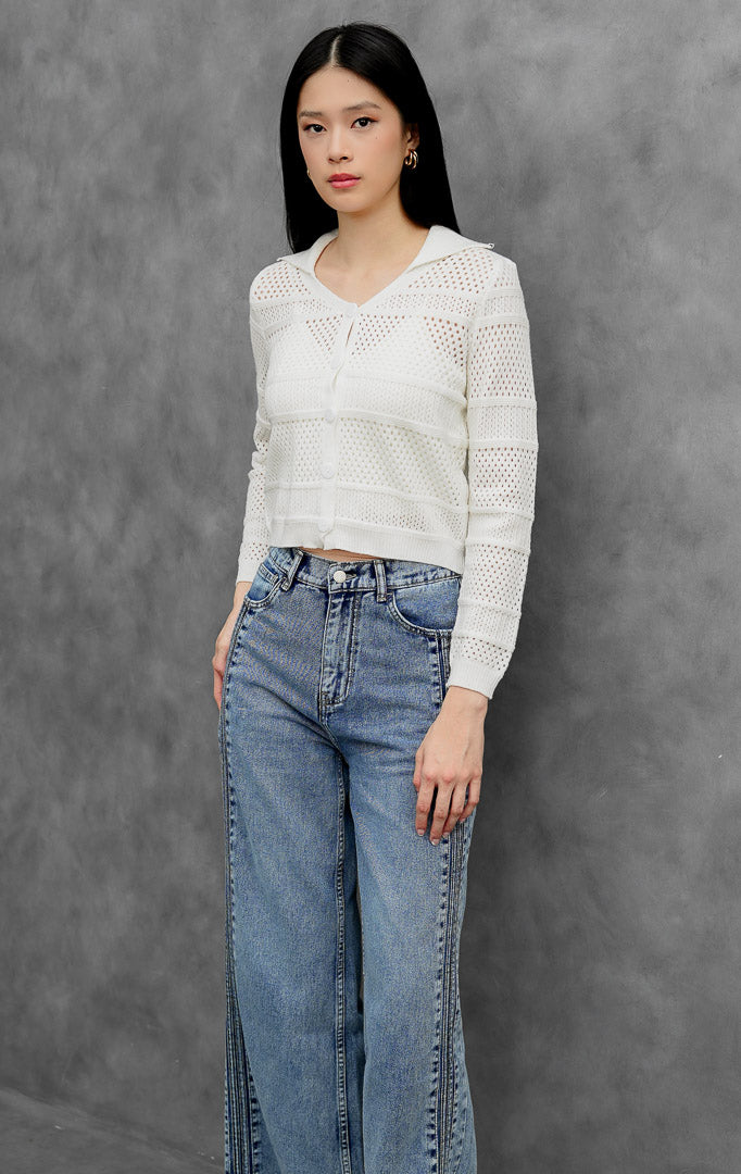 Kardigan rajut wanita lengan panjang warna putih (white) Cyra Cardigan berkerah kemeja dengan tekstur motif rajut berlubang (perforated ridge) dan bukaan kancing depan.