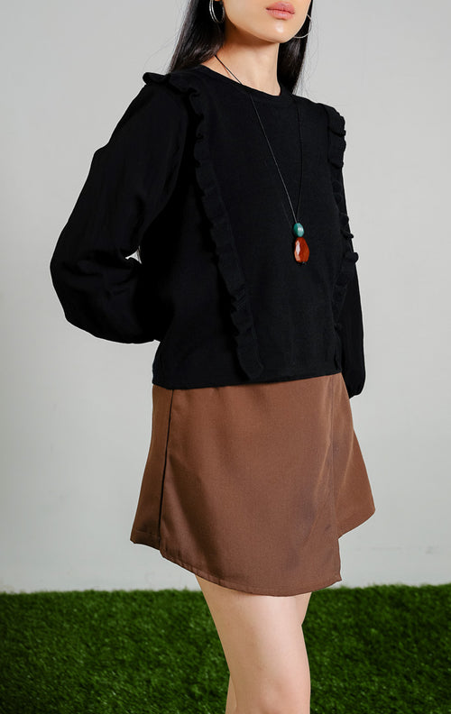 Romulus Tuxedo Ruffle Trim Knit Sweater warna black, baju sweter rajut lengan panjang balon wanita warna hitam dengan detail rumbai kerut vertikal depan dari This Is April. 