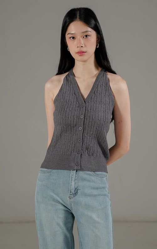 Anazelia Top Dark Grey dari This Is April, atasan rajut crop tanpa lengan (halter style) dengan kancing aktif dan tekstur cable knit.