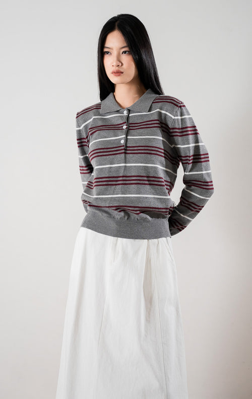 Abril Sweater, baju rajut berkerah warna abu abu dengan motif garis horizontal putih dan merah marun, serta kancing depan.