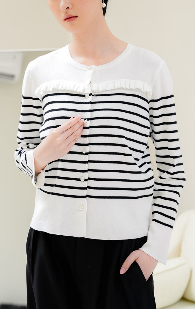 Cardigan rajut wanita warna putih motif garis hitam Alexiz Cardigan dengan detail frill, lengan panjang, dan kancing depan (button closure). 