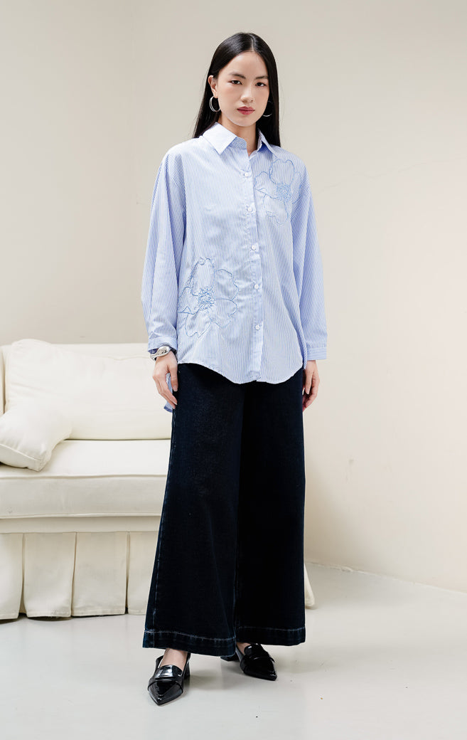 Kemeja lengan panjang wanita Amour Top warna blue (biru) bermotif stripe (salur) dengan detail bordir bunga (floral embroidery) dan kerah kemeja klasik