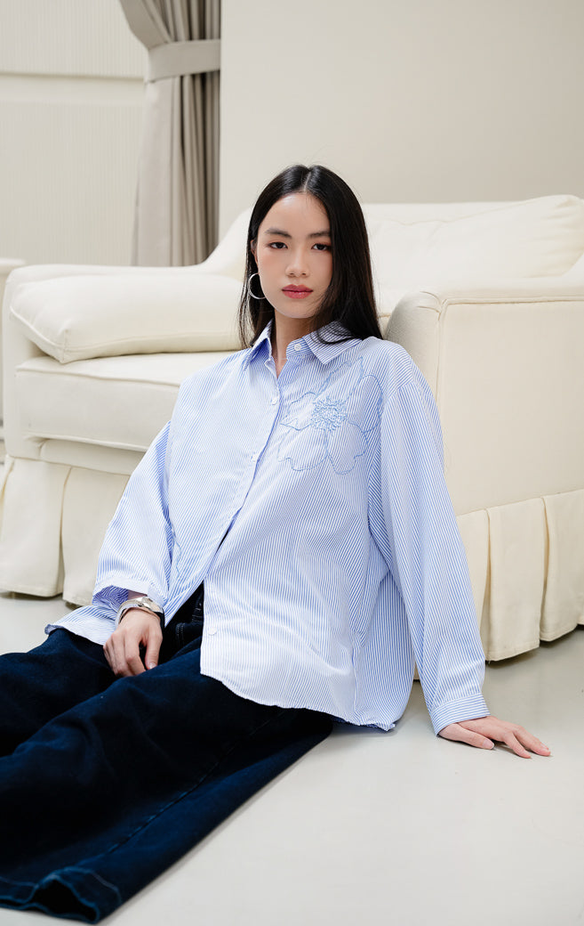 Kemeja lengan panjang wanita Amour Top warna blue (biru) bermotif stripe (salur) dengan detail bordir bunga (floral embroidery) dan kerah kemeja klasik