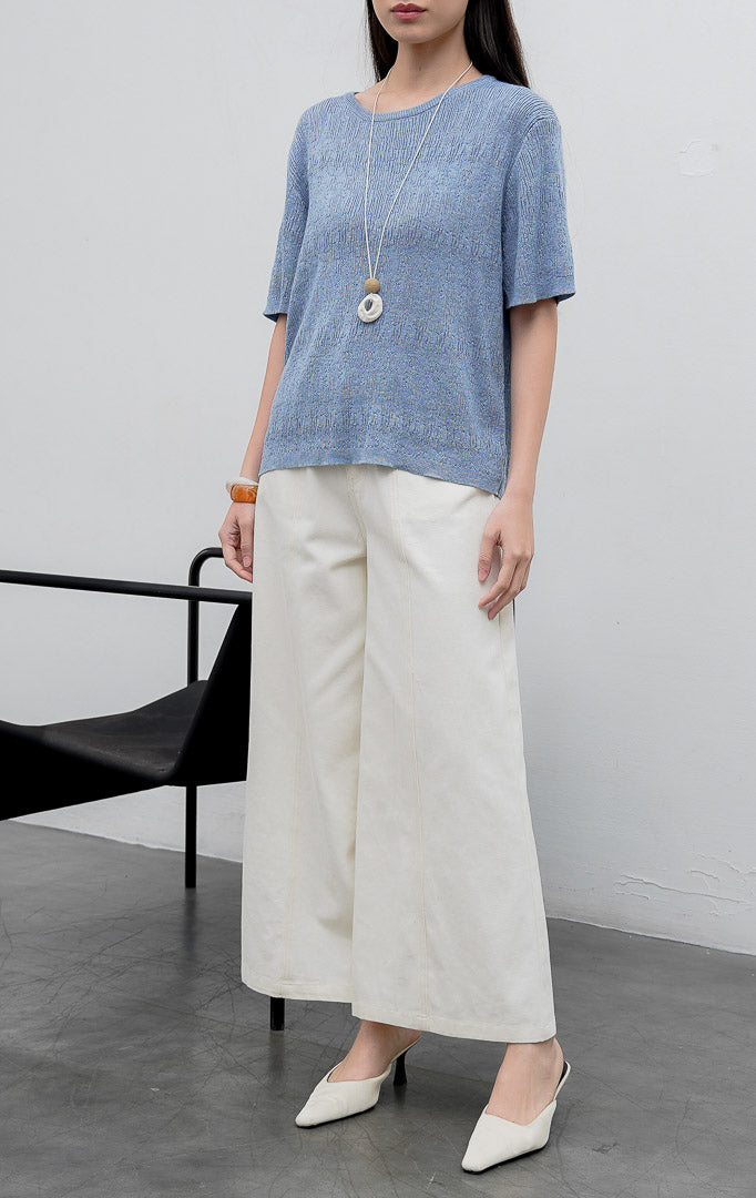 Atasan rajut wanita lengan pendek warna biru (blue) Anatella Top dengan kerah bulat (crew-neck) dan tekstur rajut halus (fine textured knit).
