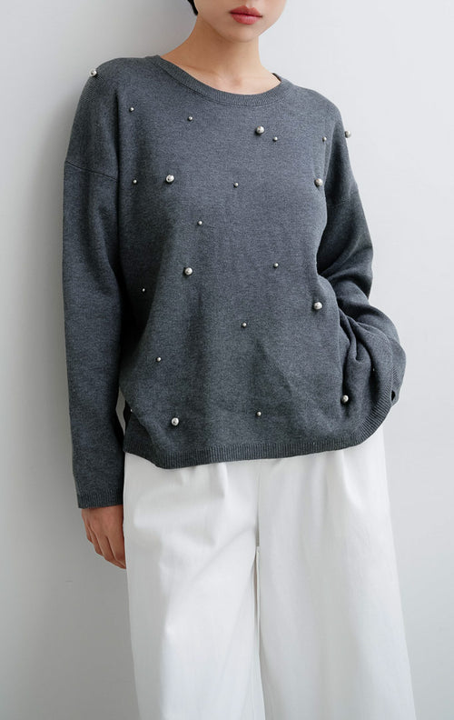 Sweater rajut wanita warna abu-abu tua (dark grey) Ardena Sweater dengan aksen hiasan metal studs, kerah bulat (round neckline), dan potongan relaxed fit.