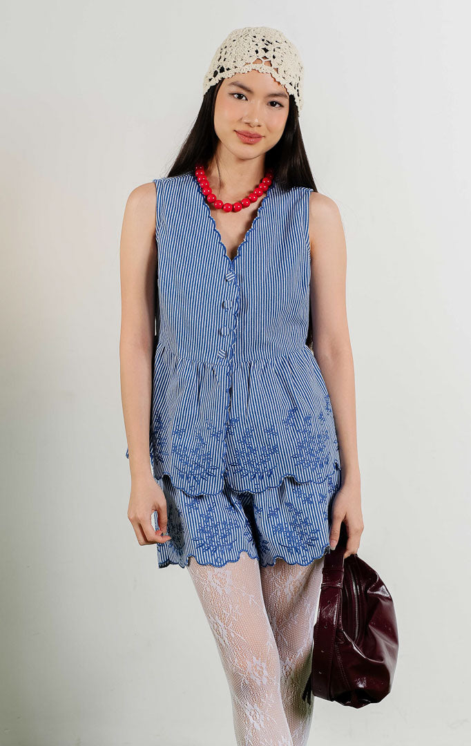 Edwynna Embroidered Floral Stripe Peplum Sleeveless Top warna navy, baju atasan tanpa lengan motif garis biru putih dengan aksen bordir bunga dan potongan peplum. 