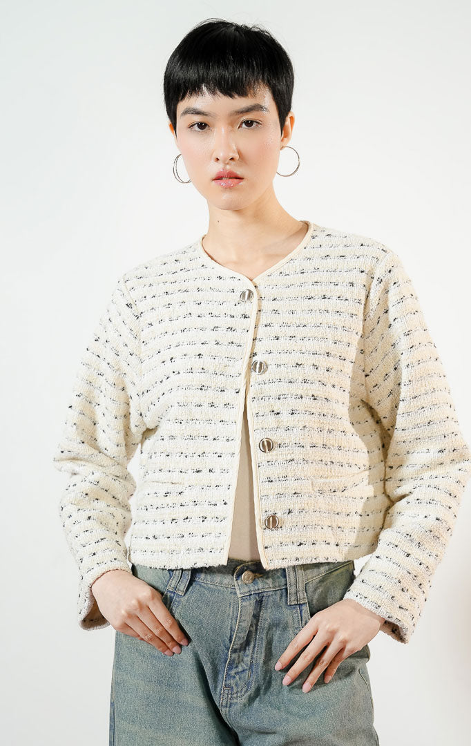 Model wanita mengenakan Carlina Tweed Blazer warna butter yellow, luaran outer blazer tweed wanita lengan panjang berwarna kuning mentega dengan kancing perak. 