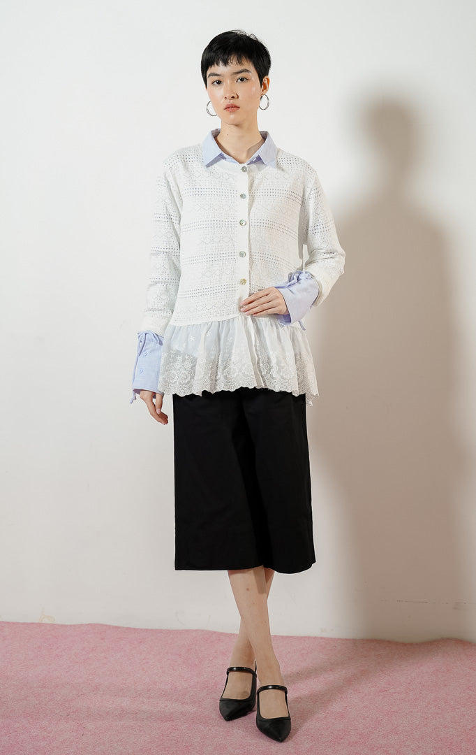Model wanita mengenakan Carolene Embroidered Peplum Knit Cardigan warna white, luaran cardigan rajut wanita berwarna putih dengan kombinasi kelim bawah peplum bordir bunga transparan.