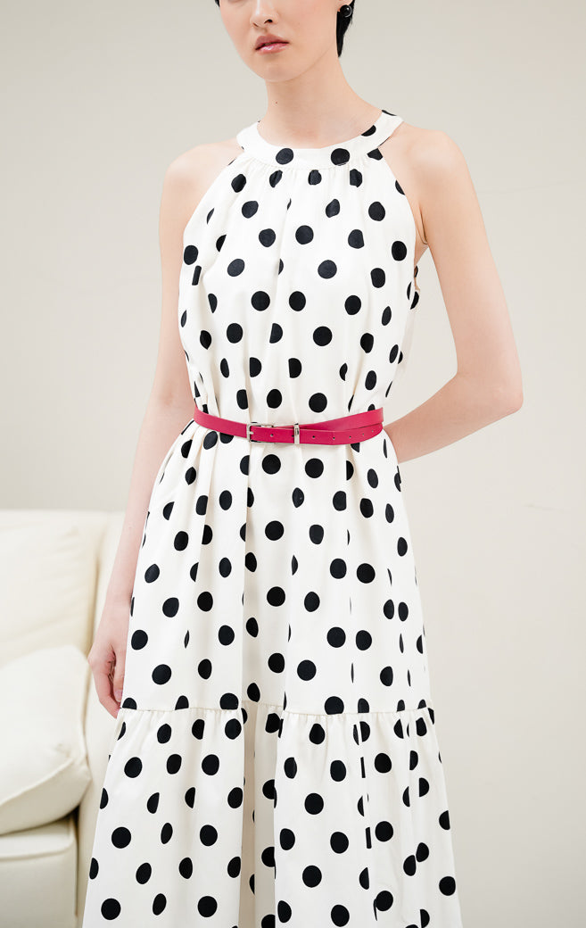 Dress wanita tanpa lengan motif polkadot warna ivory (krem/putih gading) Domino Dress dengan model halter neck, detail gathered, dan furing penuh.