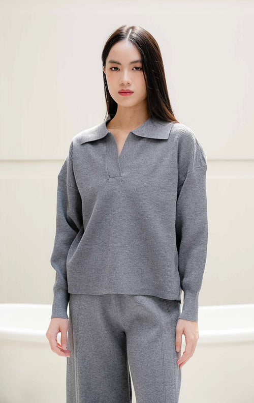 One set pakaian wanita Fernanda Set warna grey abu-abu berbahan rajut (knit) halus, terdiri dari atasan lengan panjang kerah v-neck dan celana rajut panjang detail kancing serta belahan slit. 