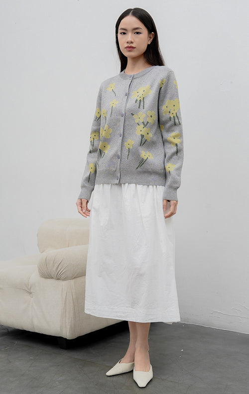 Sweter rajut wanita lengan panjang warna abu-abu (grey) Fleur Sweater dengan motif bunga kuning (floral print), kerah bulat (crew neck), dan kancing depan.