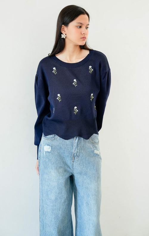Sweter rajut wanita lengan panjang warna biru navy Ingrid Sweater berpotongan relaxed fit dengan kerah bulat (round neckline) dan detail bordir motif bunga (floral embroidery). 