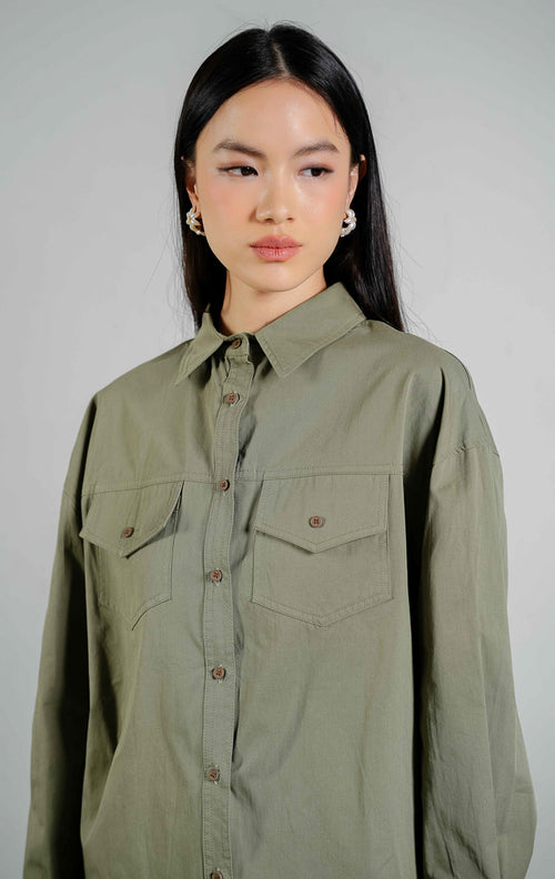 Donnelly Button-Up Shirt Top warna olive, kemeja lengan panjang wanita model utilitas bahan katun dengan dua saku depan warna hijau zaitun dari This Is April. 