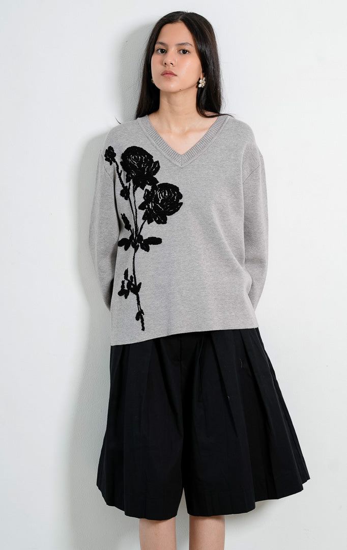 Sweter rajut wanita lengan panjang warna abu-abu (grey) Lulie Sweater berpotongan kerah V (V-neckline) dengan aksen bordir bunga mawar hitam (black floral embroidery).