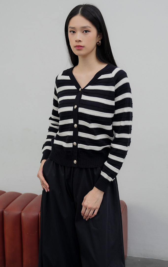 Kardigan rajut wanita lengan panjang warna hitam (black) Matera Cardigan bermotif garis horizontal (striped) bertekstur dengan kerah V (V-neck) dan bukaan kancing depan.