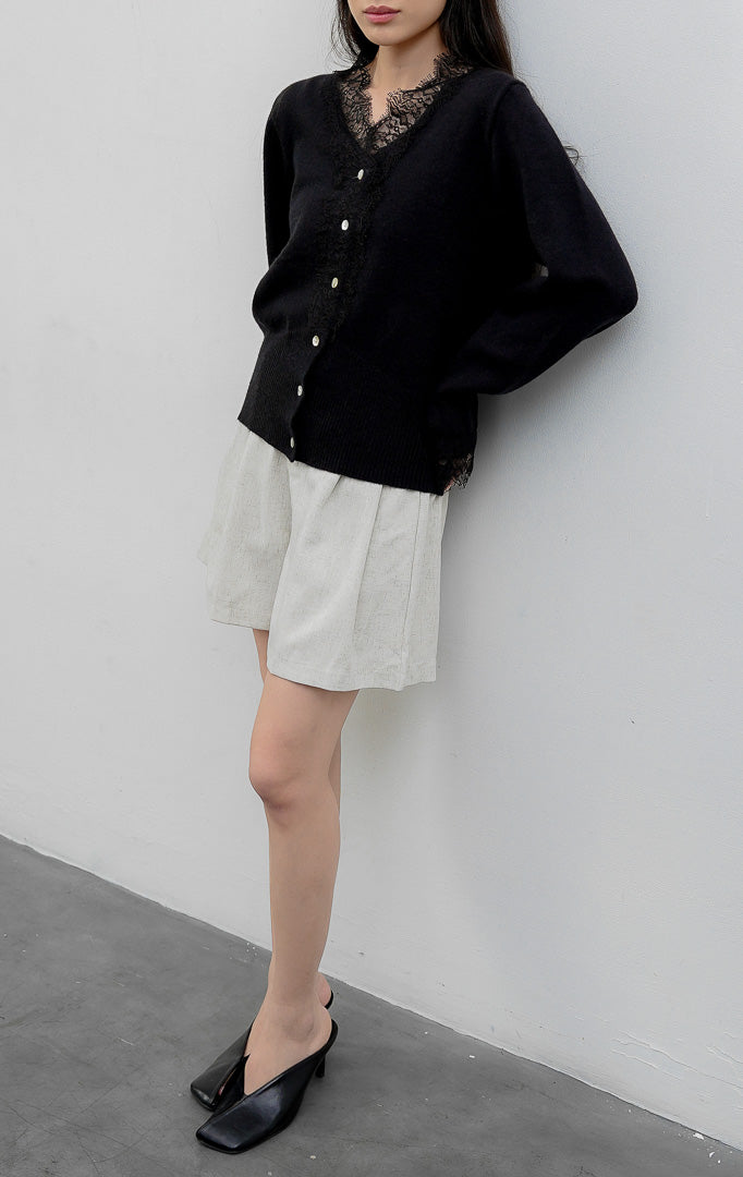 Sweter rajut wanita lengan panjang warna hitam (black) Mirabel Sweater dengan kerah V (V-neck), aksen rendetan renda halus (lace trim), dan kancing depan. 