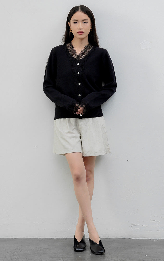 Sweter rajut wanita lengan panjang warna hitam (black) Mirabel Sweater dengan kerah V (V-neck), aksen rendetan renda halus (lace trim), dan kancing depan. 