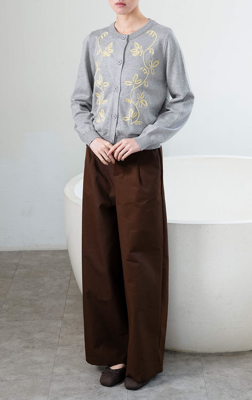 Kardigan rajut wanita lengan panjang warna abu-abu (grey) Oriana Cardigan berbahan soft knit dengan kerah bulat (rounded neckline), bukaan kancing depan, dan bordir motif sulur bunga warna kontras (contrasting floral vine embroidery). 

