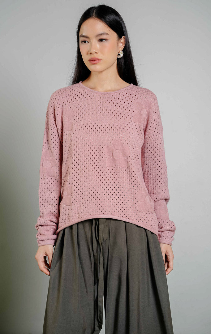 August Perforated Pointelle Flower Knit Sweater warna pink, baju sweter rajut lengan panjang wanita warna merah muda dengan motif rajutan bunga berlubang halus dari This Is April. 