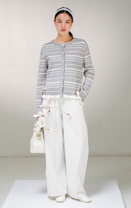 Kardigan rajut lengan panjang wanita This Is April Belmont Cardigan warna abu-abu motif garis horisontal putih, model kerah bulat dengan kancing depan, serta aksen rempel ruffle warna putih di ujung lengan dan tepian bawah. 