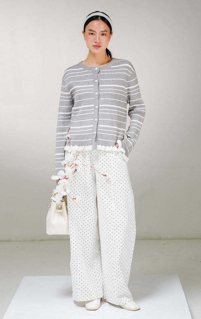 Kardigan rajut lengan panjang wanita This Is April Belmont Cardigan warna abu-abu motif garis horisontal putih, model kerah bulat dengan kancing depan, serta aksen rempel ruffle warna putih di ujung lengan dan tepian bawah. 