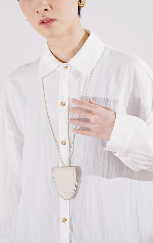 Kemeja wanita lengan panjang Caelia Top dari This Is April berwarna putih bersih dengan detail kancing depan, berbahan ringan, 