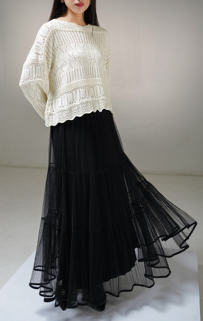 Atasan sweater rajut lengan panjang wanita This Is April Clarissa Sweater warna ivory (krem terang), model jaring mesh knit transparan dengan pola rajutan belah ketupat dan garis vertikal. 
