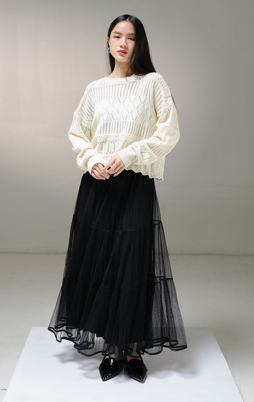 Atasan sweater rajut lengan panjang wanita This Is April Clarissa Sweater warna ivory (krem terang), model jaring mesh knit transparan dengan pola rajutan belah ketupat dan garis vertikal. 