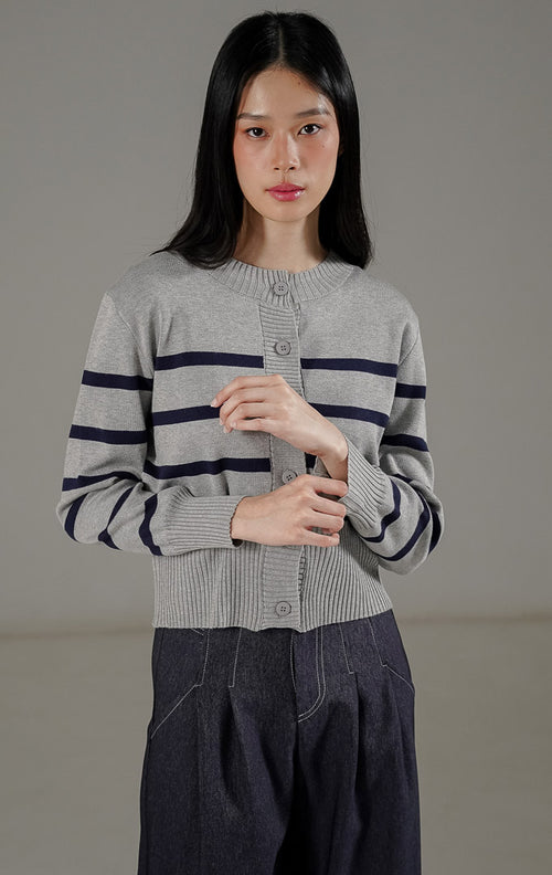  Darcy Cardigan Grey dari This Is April, cardigan rajut lengan panjang warna abu-abu dengan motif garis-garis navy dan kancing depan.