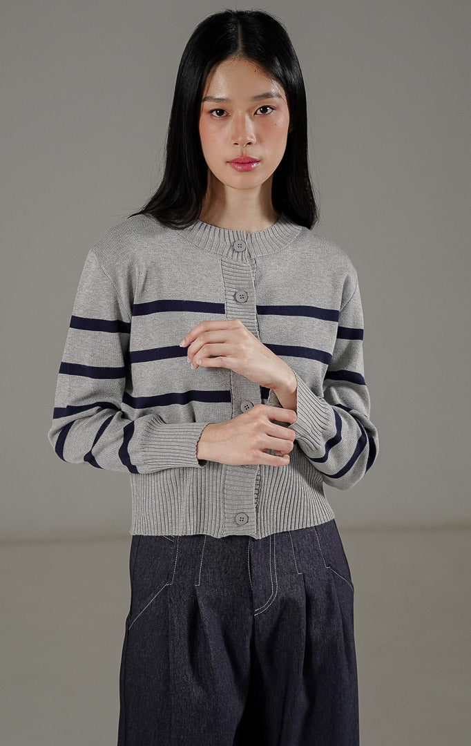  Darcy Cardigan Grey dari This Is April, cardigan rajut lengan panjang warna abu-abu dengan motif garis-garis navy dan kancing depan.