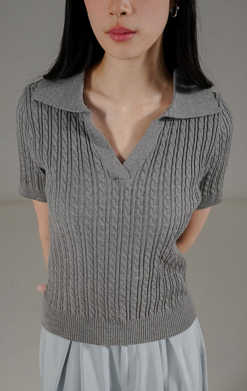Eiden Top Dark Grey dari This Is April, atasan rajut lengan pendek warna abu-abu tua dengan motif cable knit dan potongan kerah V.