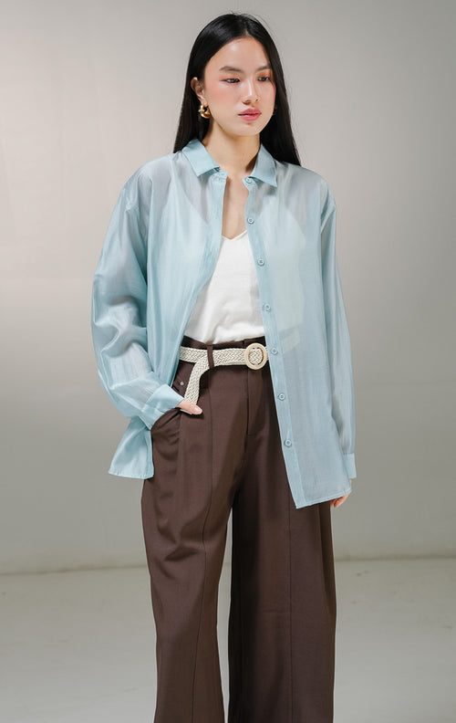 Kemeja lengan panjang wanita This Is April Favino Top warna biru mint, model oversized shirt dengan material kain sheer transparan halus yang menerawang dan detail kancing depan hidup.